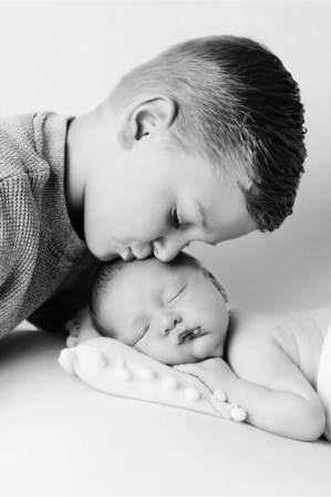 Black and White image newborn photo with elder brother, photo by Jayne Poole Photography based in Torrington, near Bideford, Barnstaple, South Molton, Crediton, Okehampton, Holsworth Bude, Clovelly, Westward HJo, Roundswel, Croyde in Devon