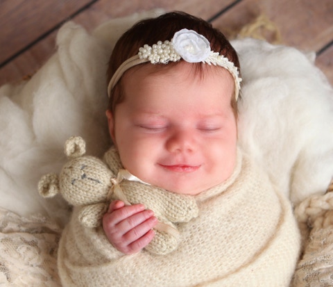 Happy smiling newborn photo by Jayne Poole Photography based in North Devon, in Great Torringotn near Bideford, Barnstaple, South Molton, Braunton, Croyde, Woolacombe, Ilfracombe, Crediton, Okehampton, Holsworthy, Bude, Northam, Westward Ho, Fremington, Roundswell
