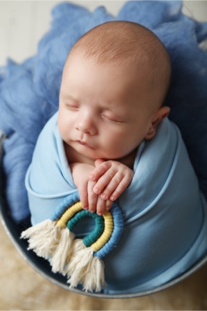 Newborn baby photograpgy baby boy in blue with rainbow, by Jayne poole Photography based in North Devon in Great Torrington near Bideford, Barnstaple, Fremeington, Braunton, South Molton, Crediton, Okehampton, Holsworthy, Bude, Northam, Westward Ho